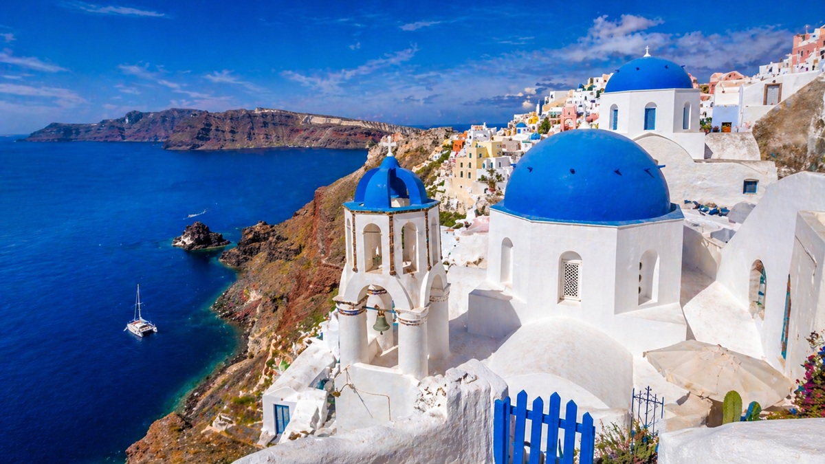 Widok na białą zabudowę Santorini nad turkusowym morzem — jedno z najpiękniejszych miejsc w Europie